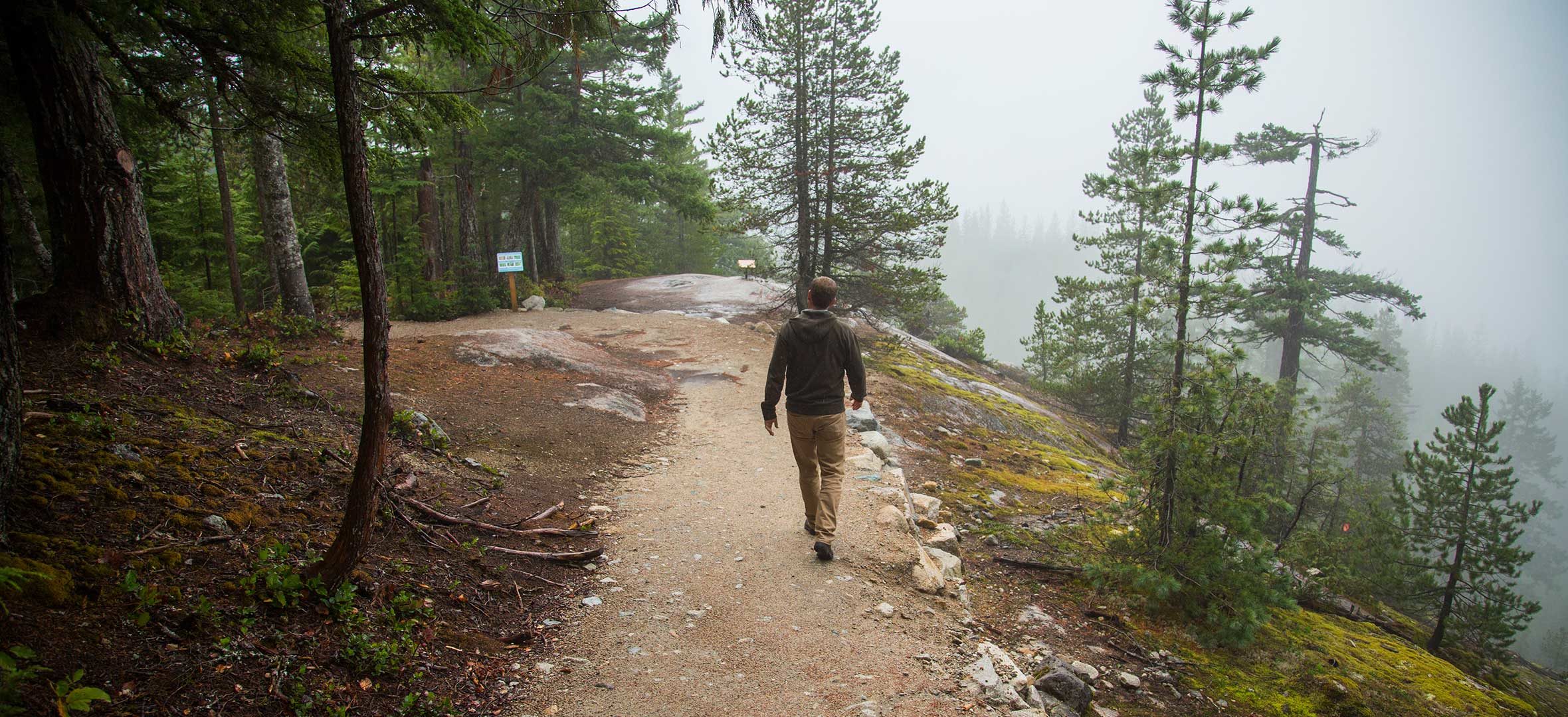 Trevor Dunn walks along a forested trail
