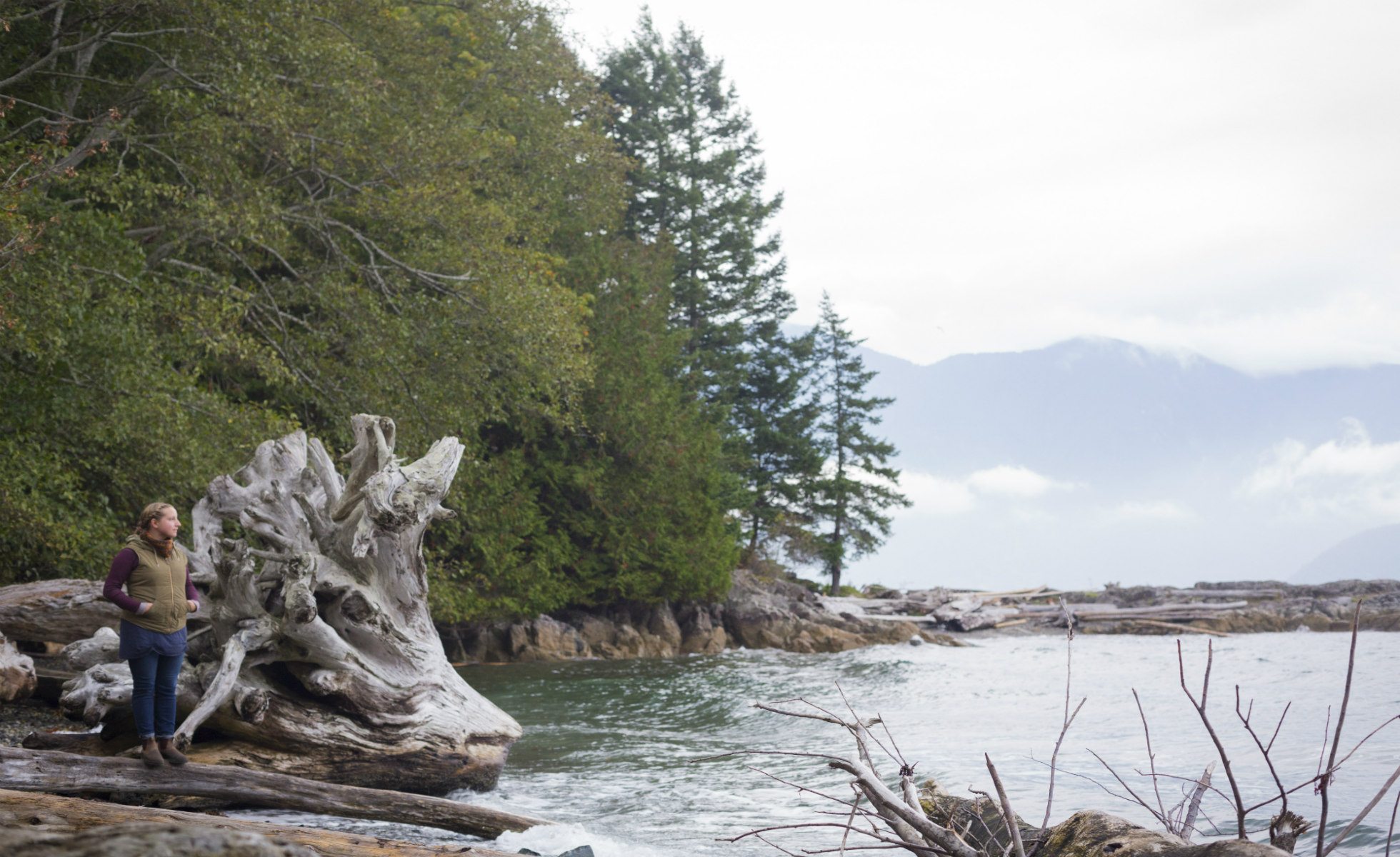A woman stands at the shore of Howe Sound