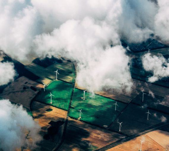 Aerial view of farmland with wind turbines