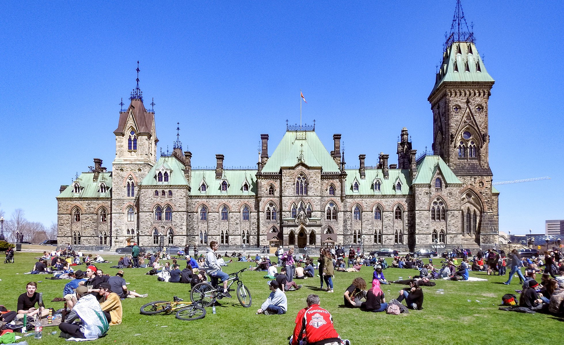 Crowds picnic on Parliament Hill in Ottawa.