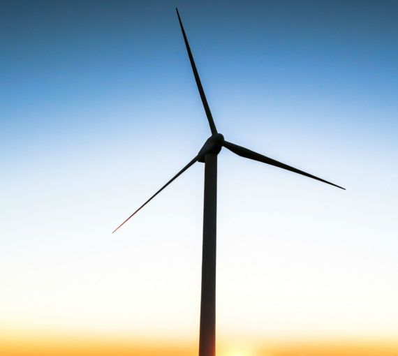 A picture of a wind turbine against the sky