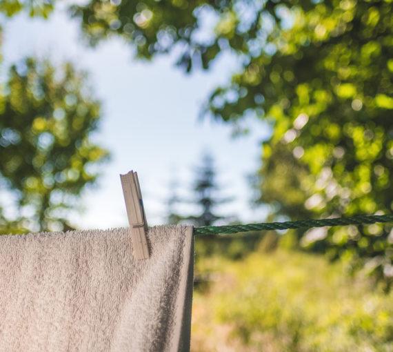 A towel drying on the clothes line outside.