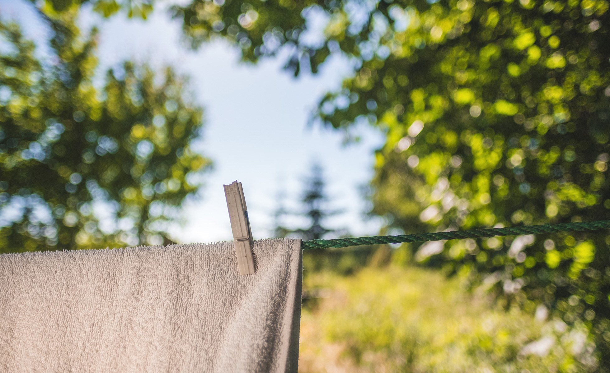 A towel drying on the clothes line outside.