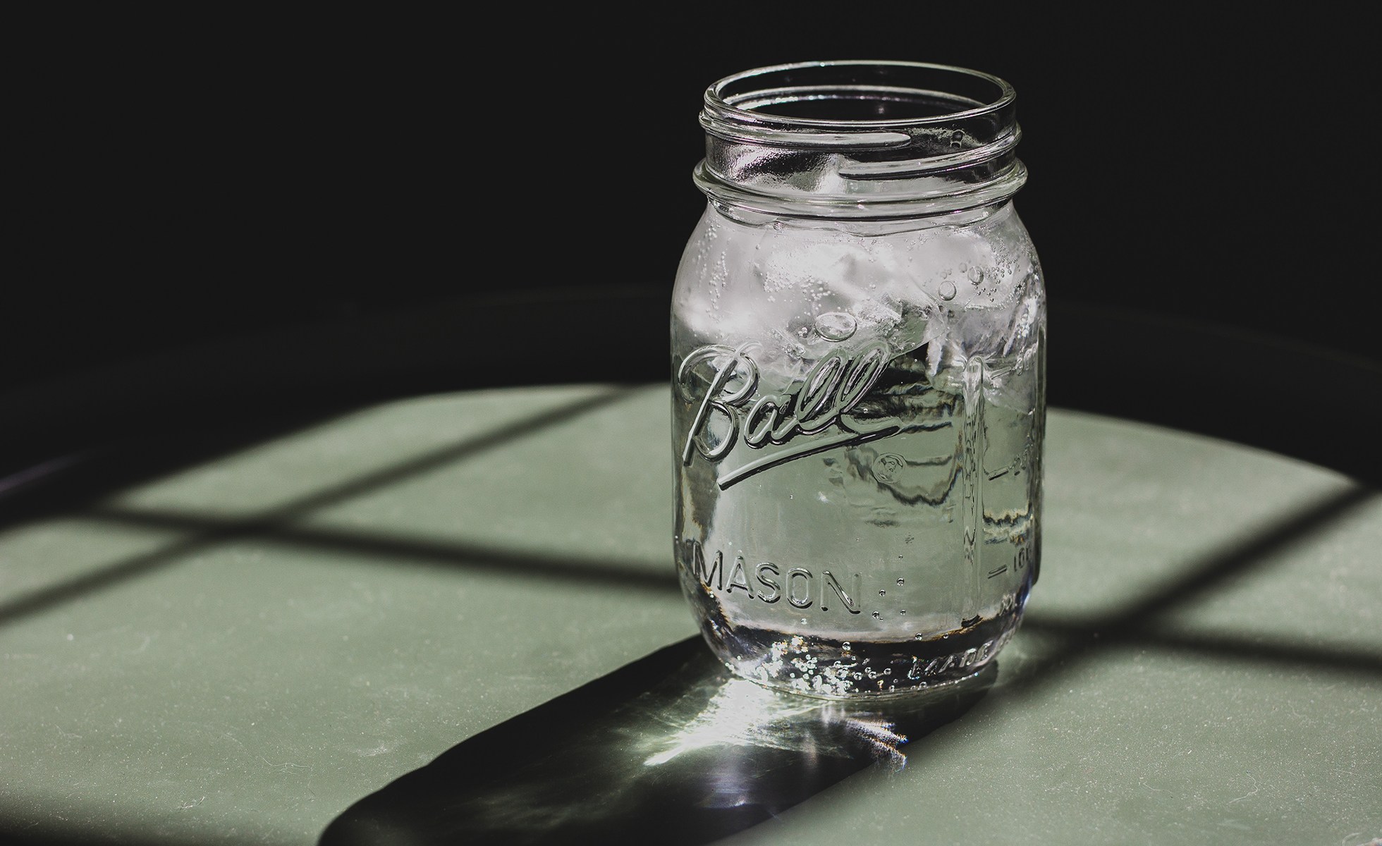A mason jar with purified ice water.
