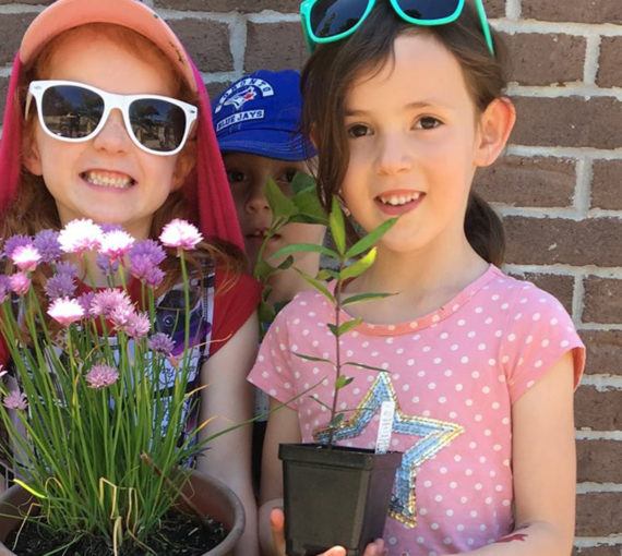 Children with pollinator-friendly plants