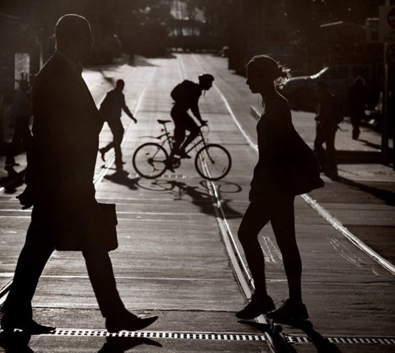 Pedestrians and cyclists in silhouette
