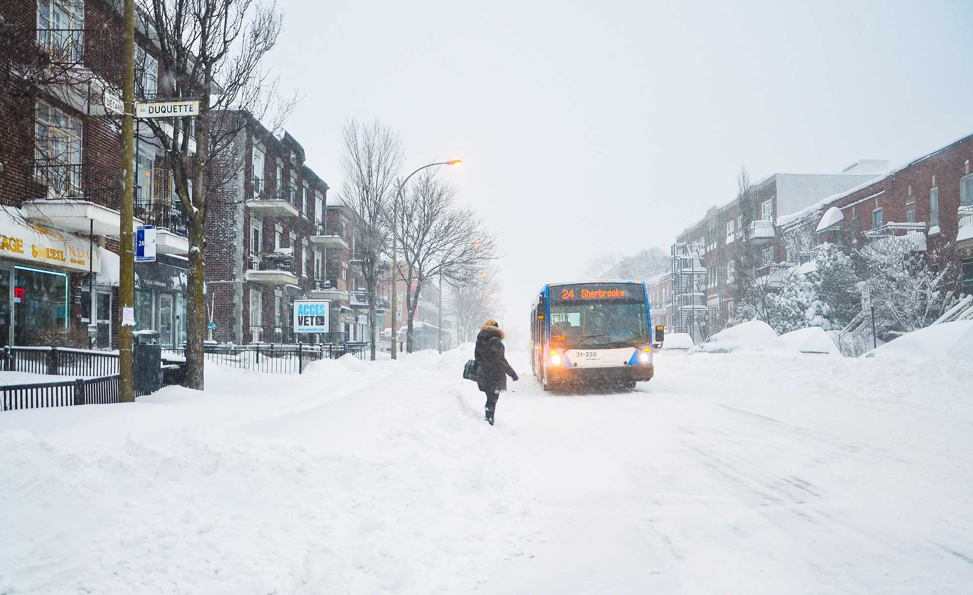 A Montreal woman waits for the bus in winter weather