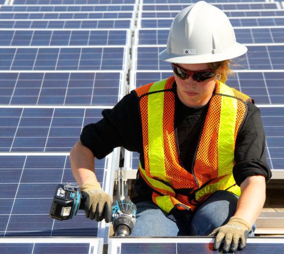Canadian solar worker installing panels