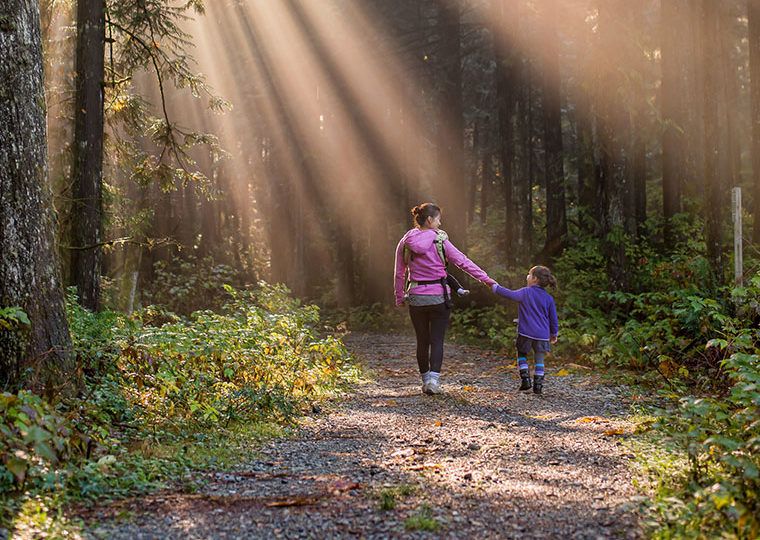 Mother and daughter walk in the woods
