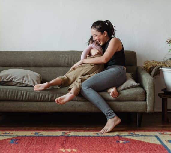 Woman hugging child on couch