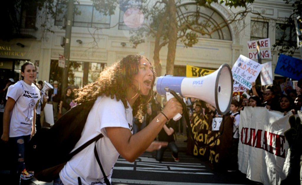 Woman on megaphone at Global Climate Strike