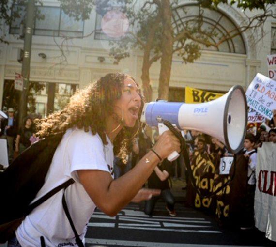 Woman on megaphone at Global Climate Strike