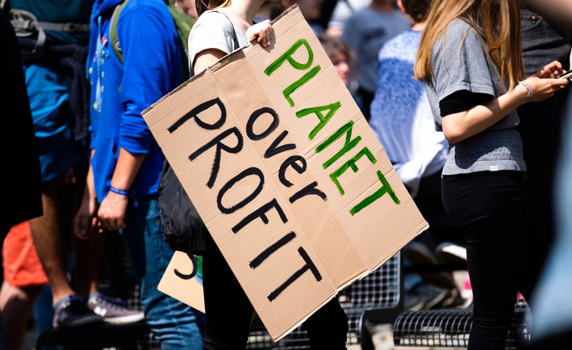 planet over profit sign