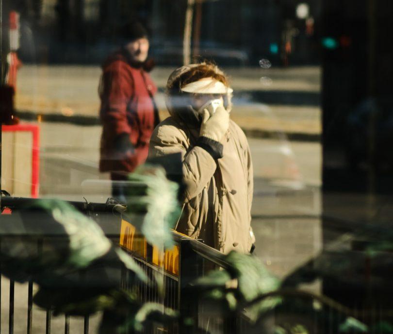 person-in-mask-through-window person in mask through window