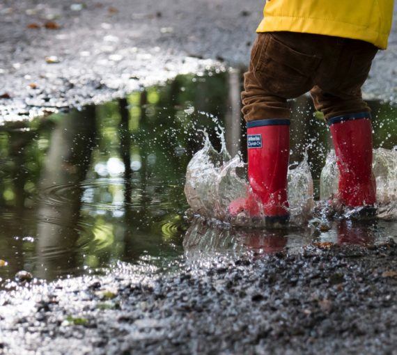 Child splashing in a puddle