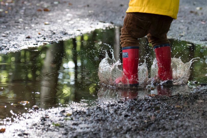 Child splashing in a puddle