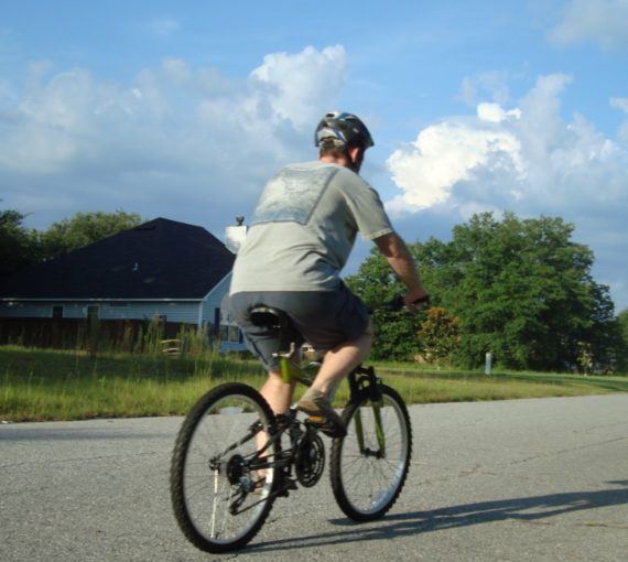 Photo of cyclist on a bike on sunny day