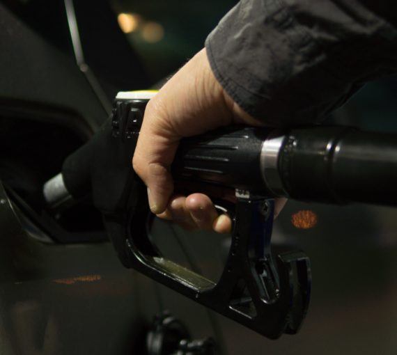 Close up of person fuelling car at gas pump