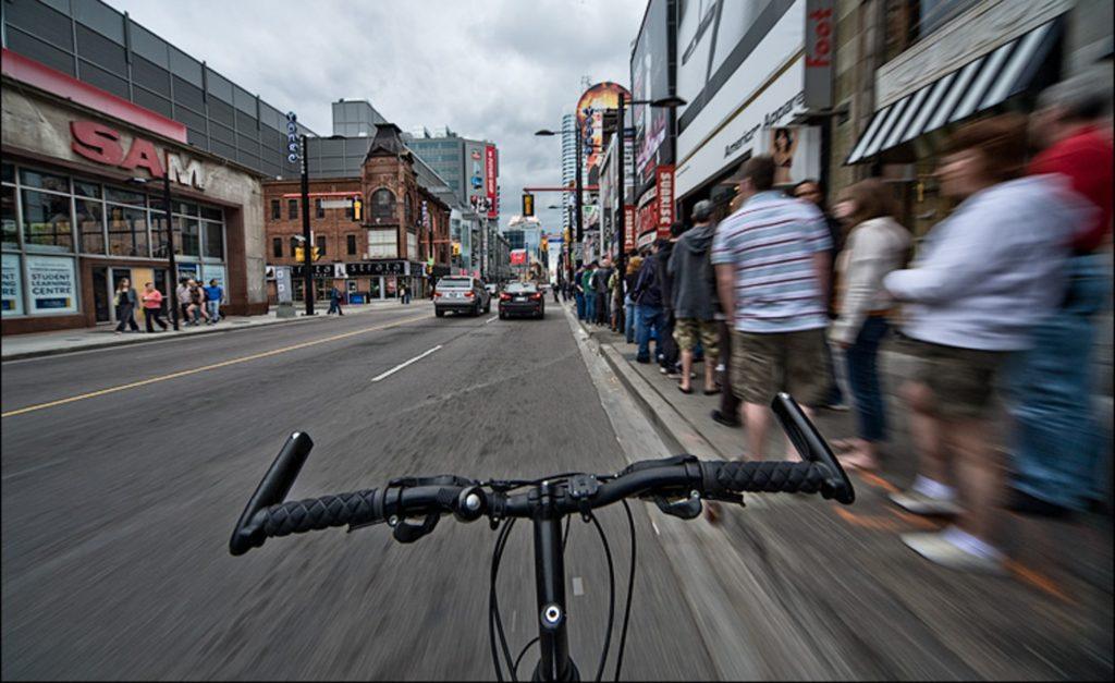 First person view of handlebars cycling through Yonge Street