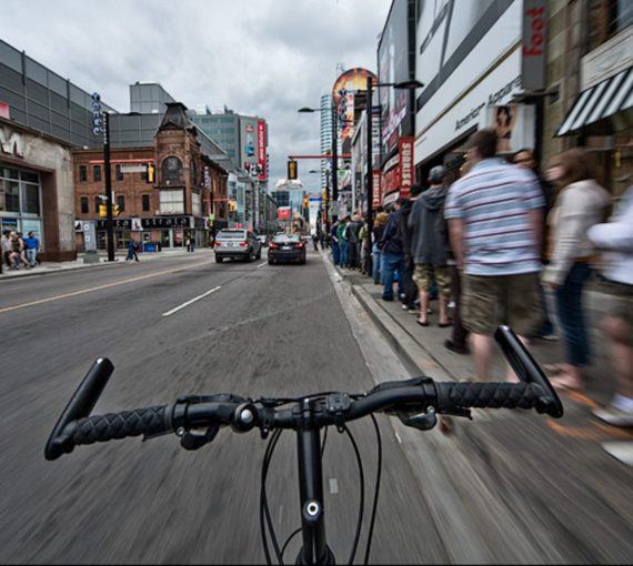 First person view of handlebars cycling through Yonge Street