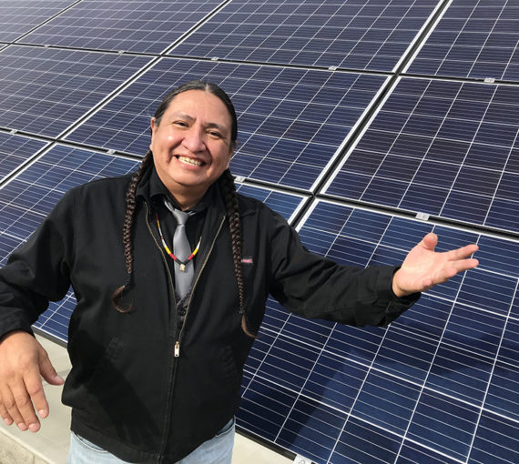 Indigenous person with solar panels