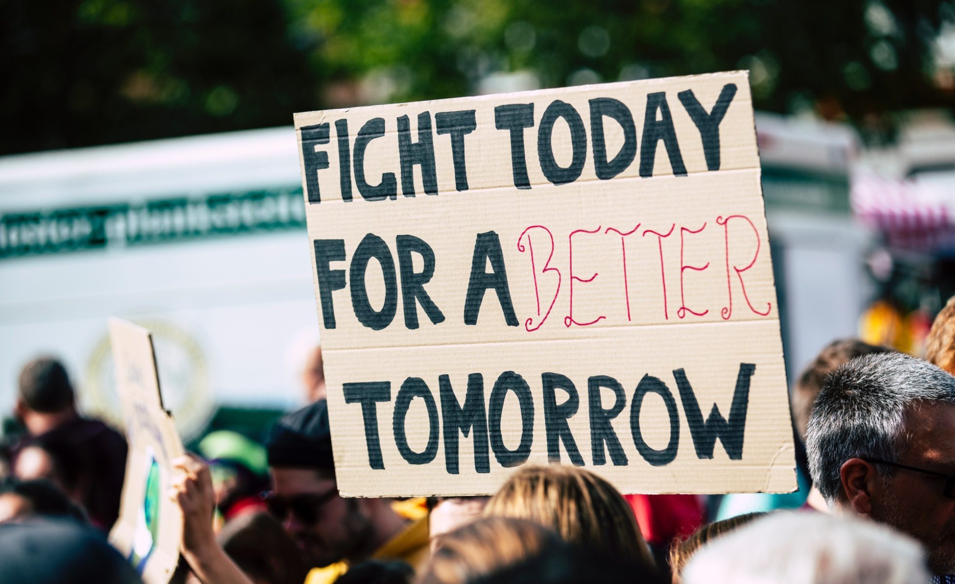 Close up of cardboard sign that says "Fight for a better tomorrow"