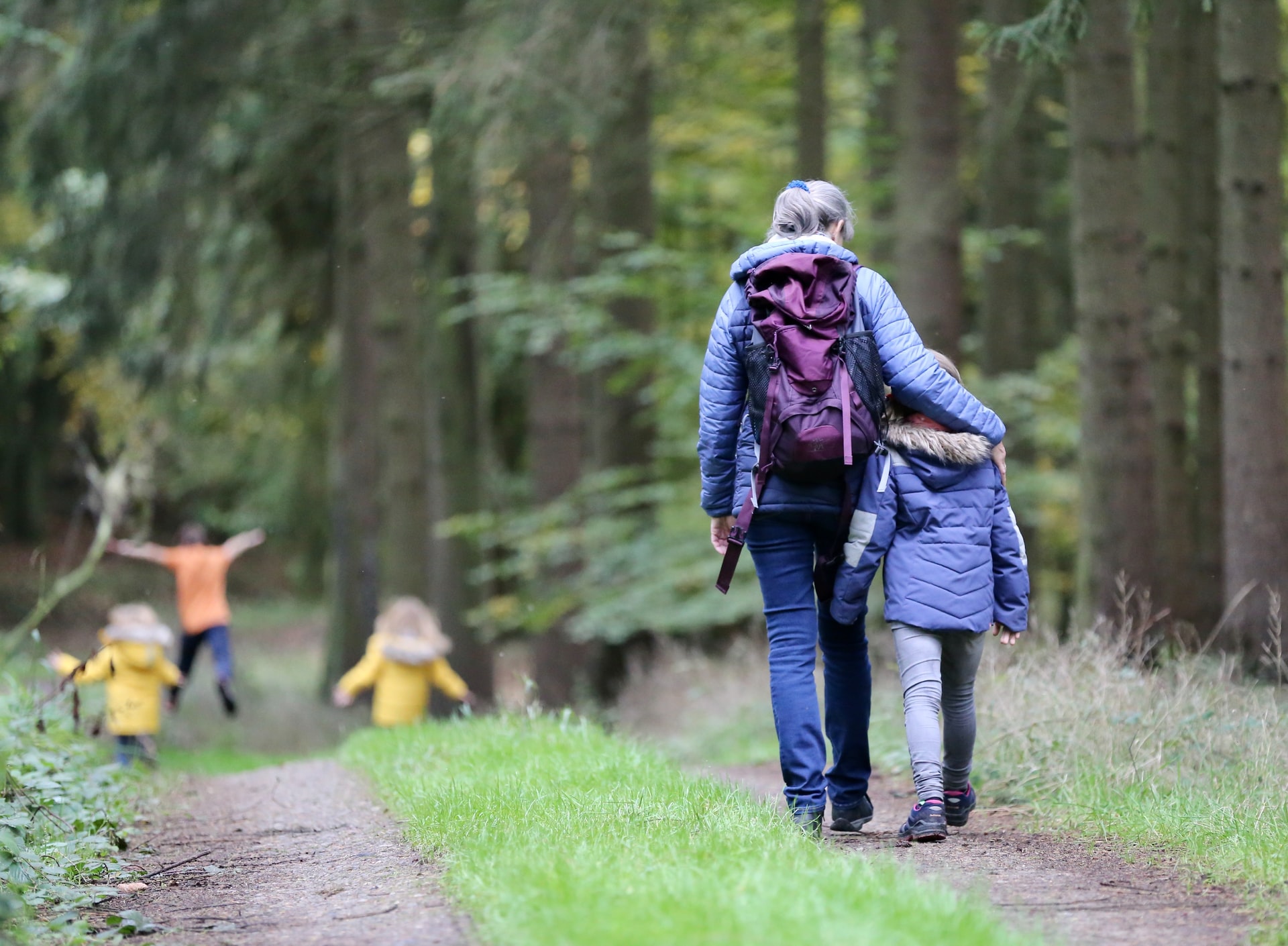 Woman and family walking in a forest