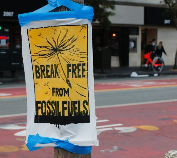 Break free from fossil fuels written across black and yellow poster.