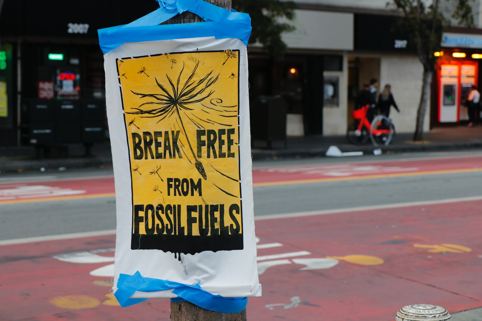 Break free from fossil fuels written across black and yellow poster.