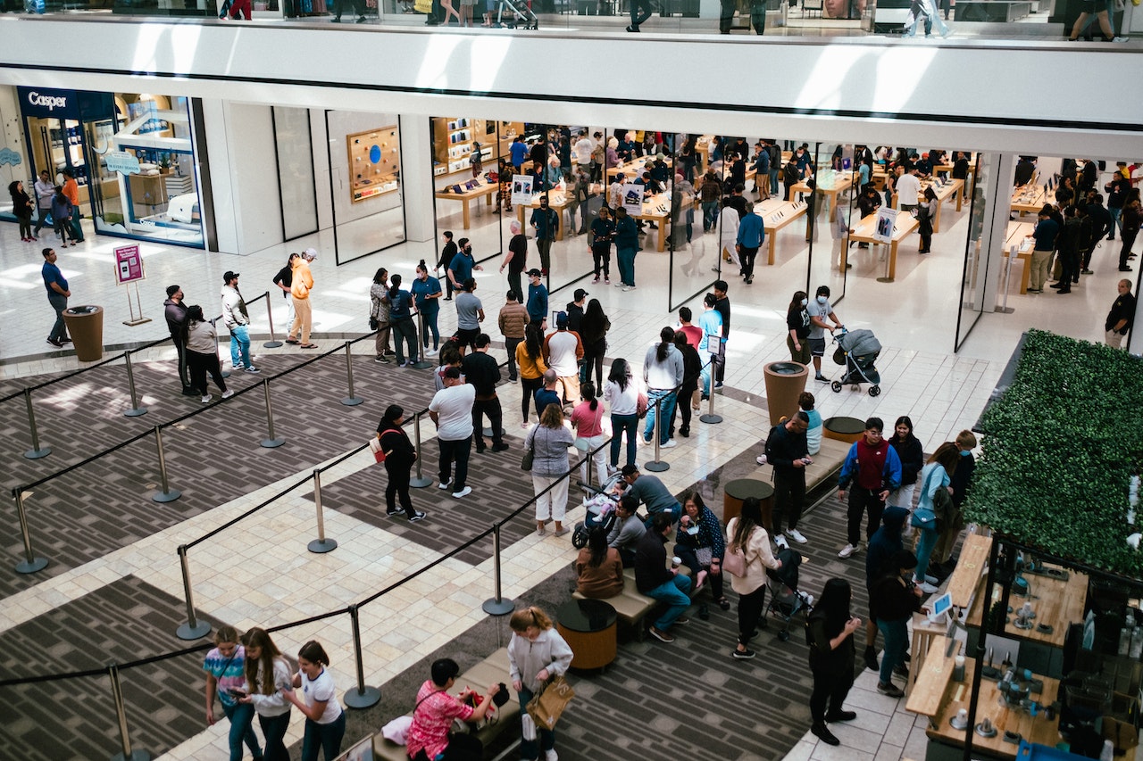 People are photographed shopping in a crowded shopping mall