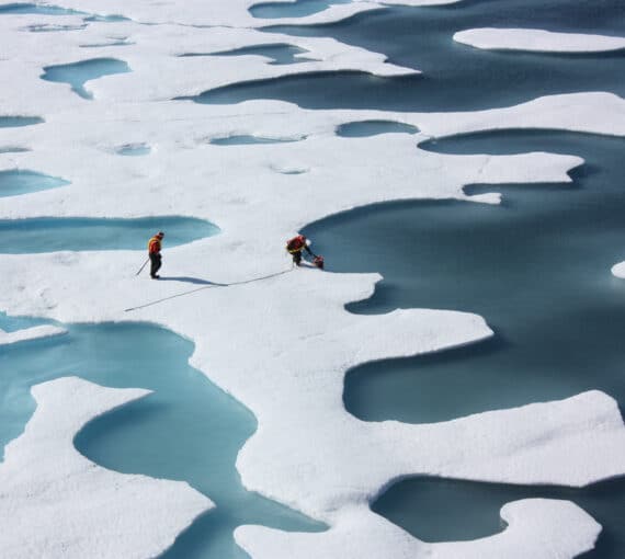NASA crew on sea ice melt ponds in the Arctic.