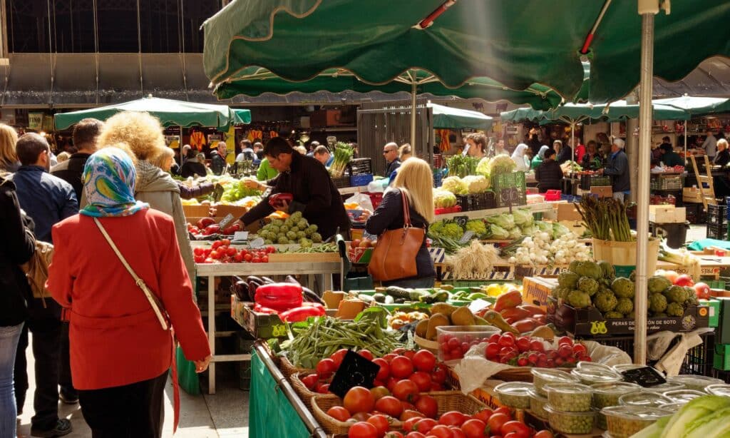 people browsing at a fruit and veg market