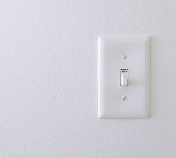 A light switch on a white wall