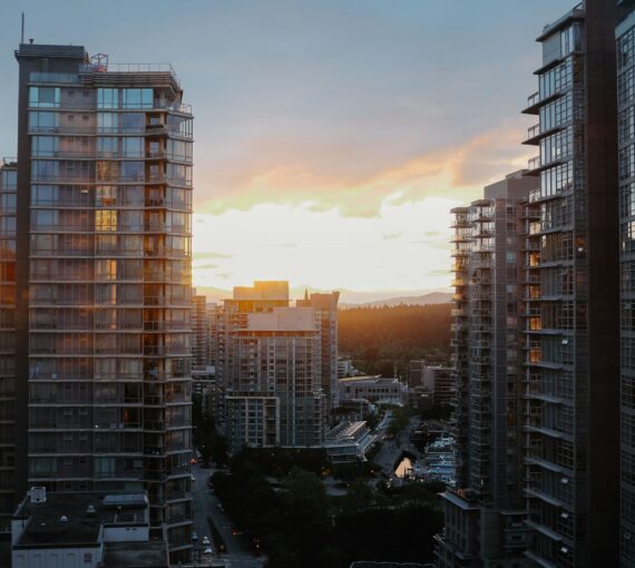 City high-rise buildings in Vancouver against a sunset