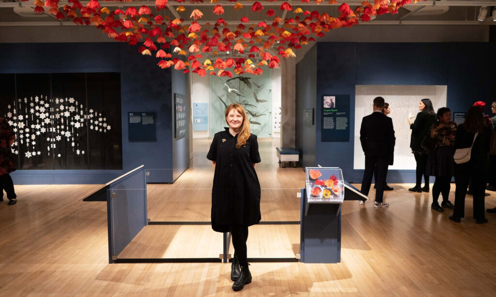 Amanda McCavour with her piece at the Canadian Museum of Nature's Rewilding exhibit