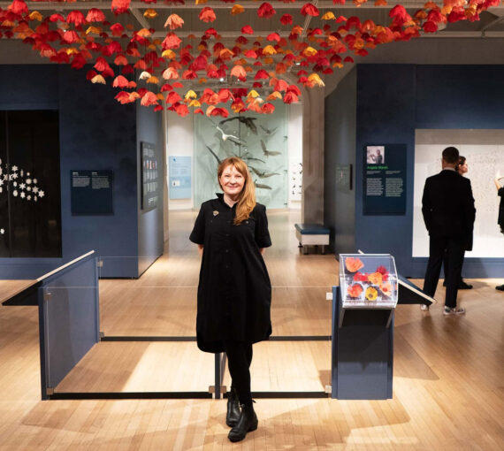 Amanda McCavour with her piece at the Canadian Museum of Nature's Rewilding exhibit