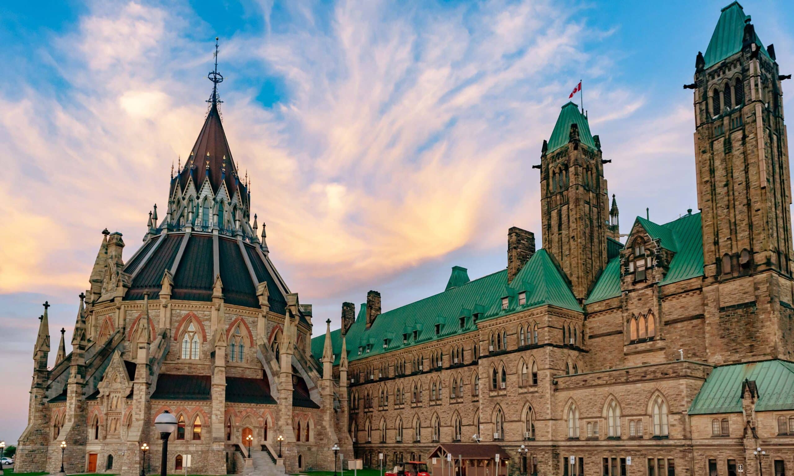 sunsetting cloudy sky behind Canadian buildings