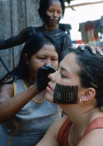 Severn Cullis-Suzuki receives traditional face painting from the Kayapo people of Brazil.