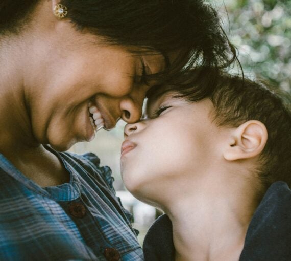 A photo of a mother and child smiling together
