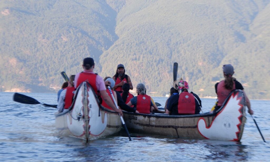 Campers in canoes learn about Squamish teachings in the middle of Howe Sound.